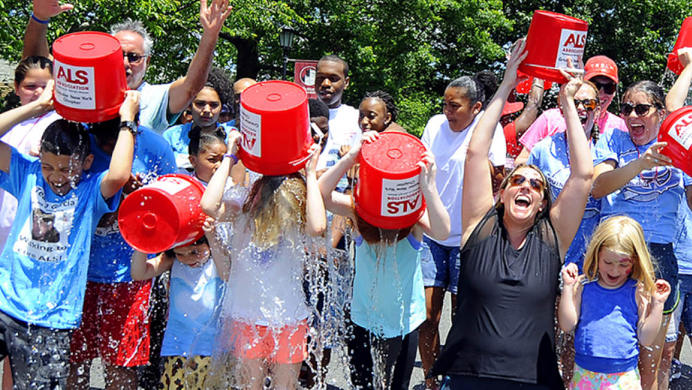 a group of people dumping ice water on themselves